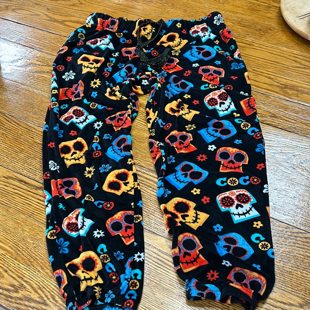 Disney Pixar Coco theme velour pajama pants. Black w/colorful skulls. Size Large
